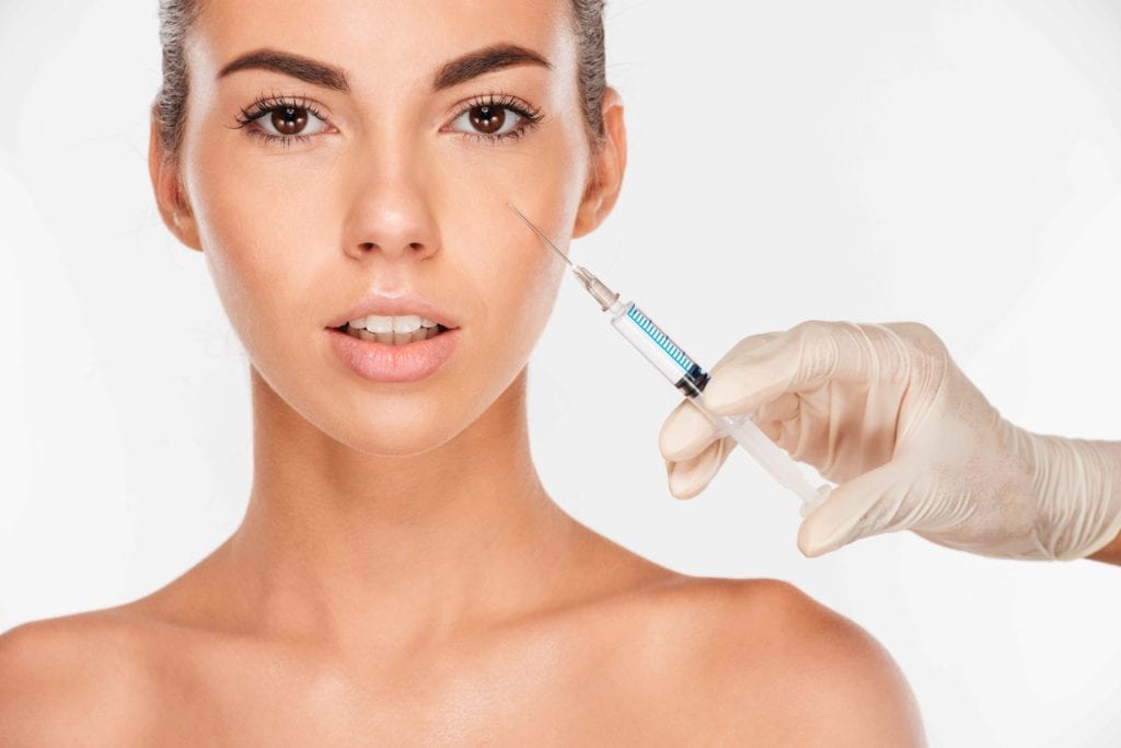 Navigating The Undereyes 2 close up of a beautiful young woman gets beauty injection in eye area with syringe iso SBI 302779281 11zon